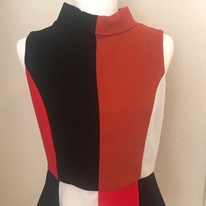 Color blocked mock turtleneck top with peplum